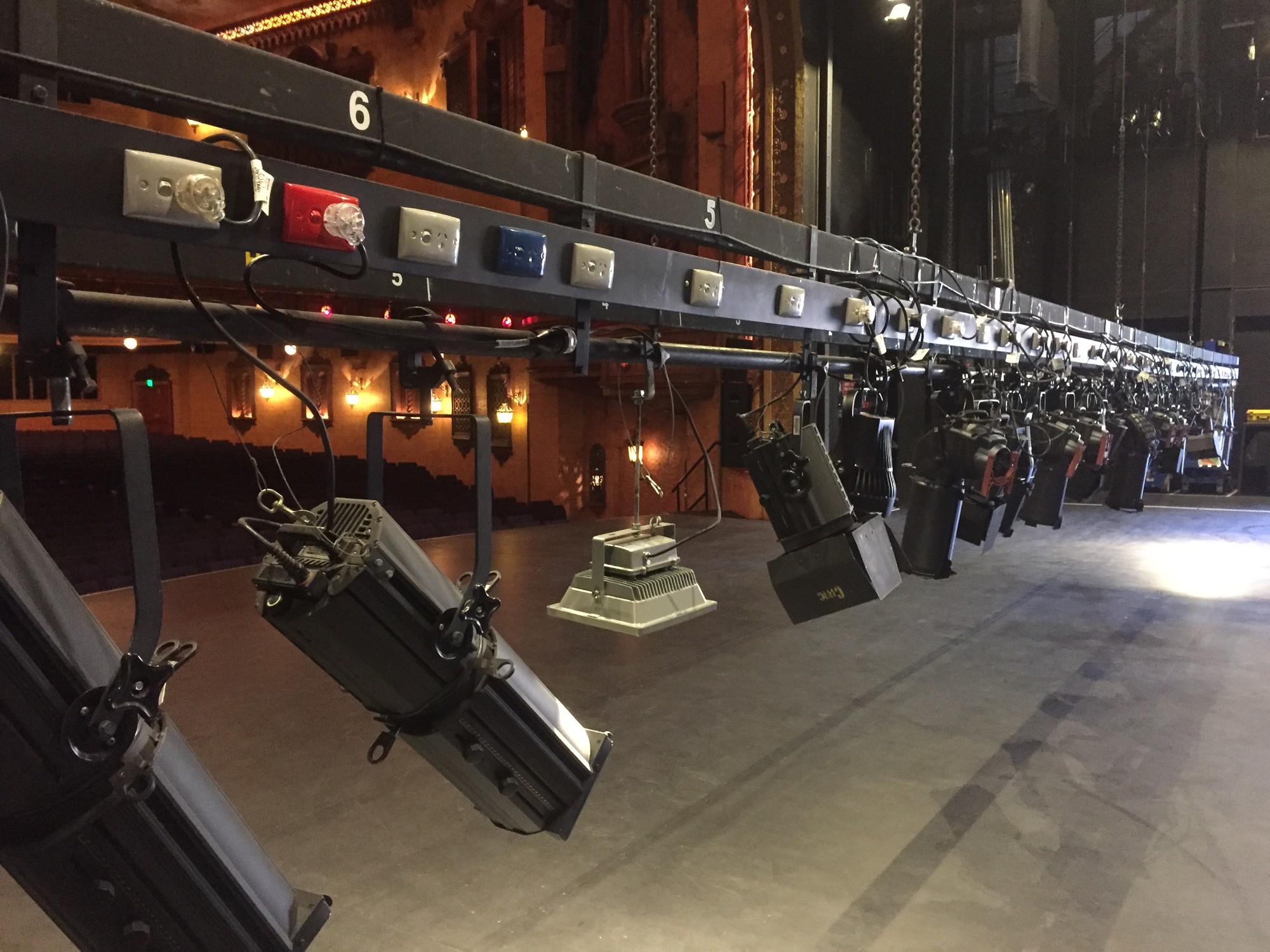 Overstage hoisting and rigging machinery in a performance venue fly tower