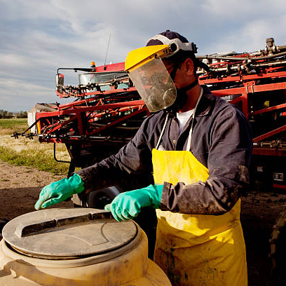 farmer with vat of chemicals