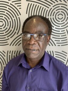 Photo of Brian in front of patterned background