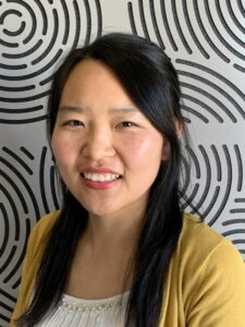 Photo of Rong in front of patterned background