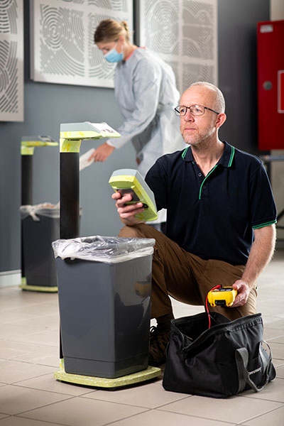 Man and woman working with SureWaste system